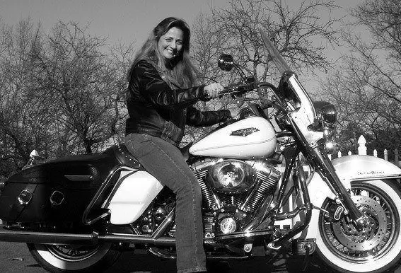 Grainy old picture of a teenage girl with a motorcycle